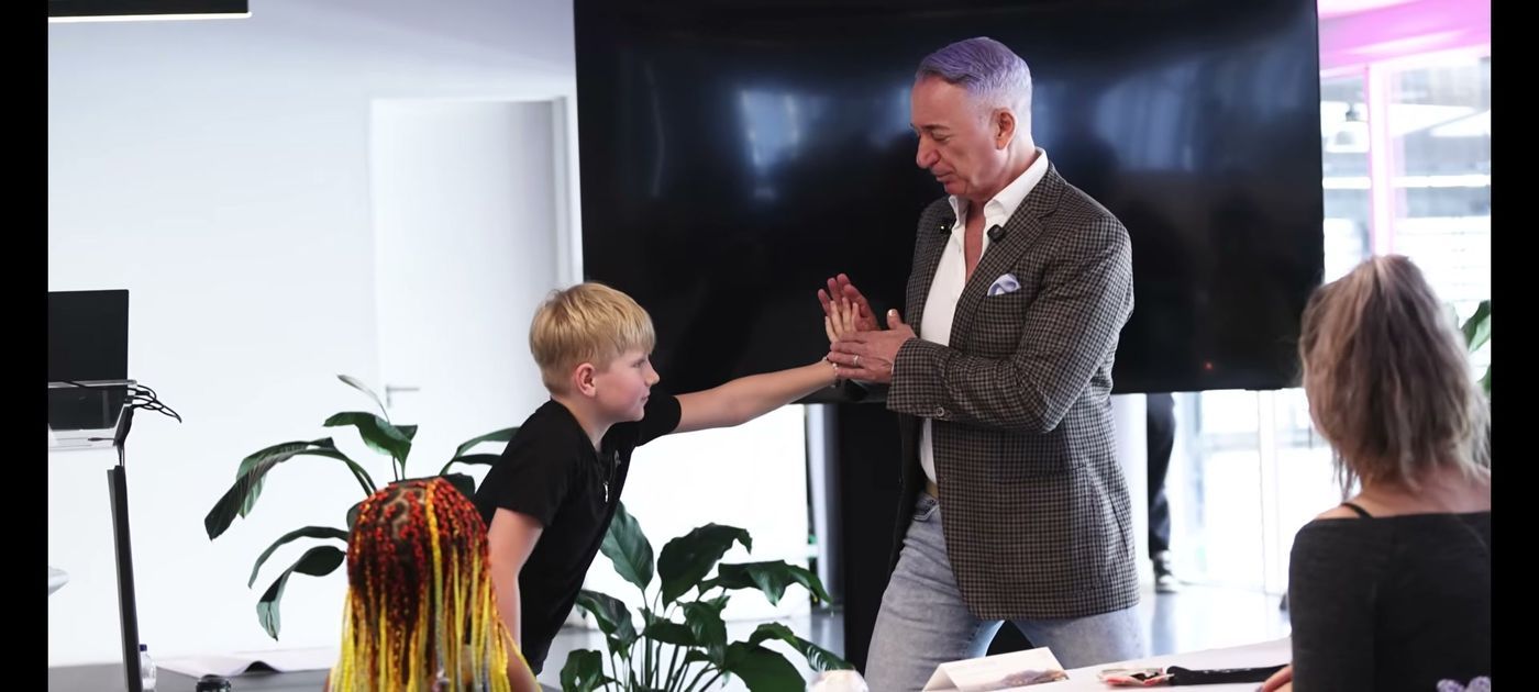 Meir on stage with a young student